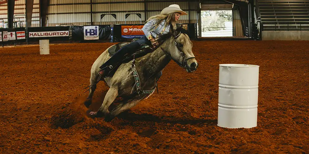 SHSU Student riding at the Sonny Sikes Arena at Gibbs Ranch.