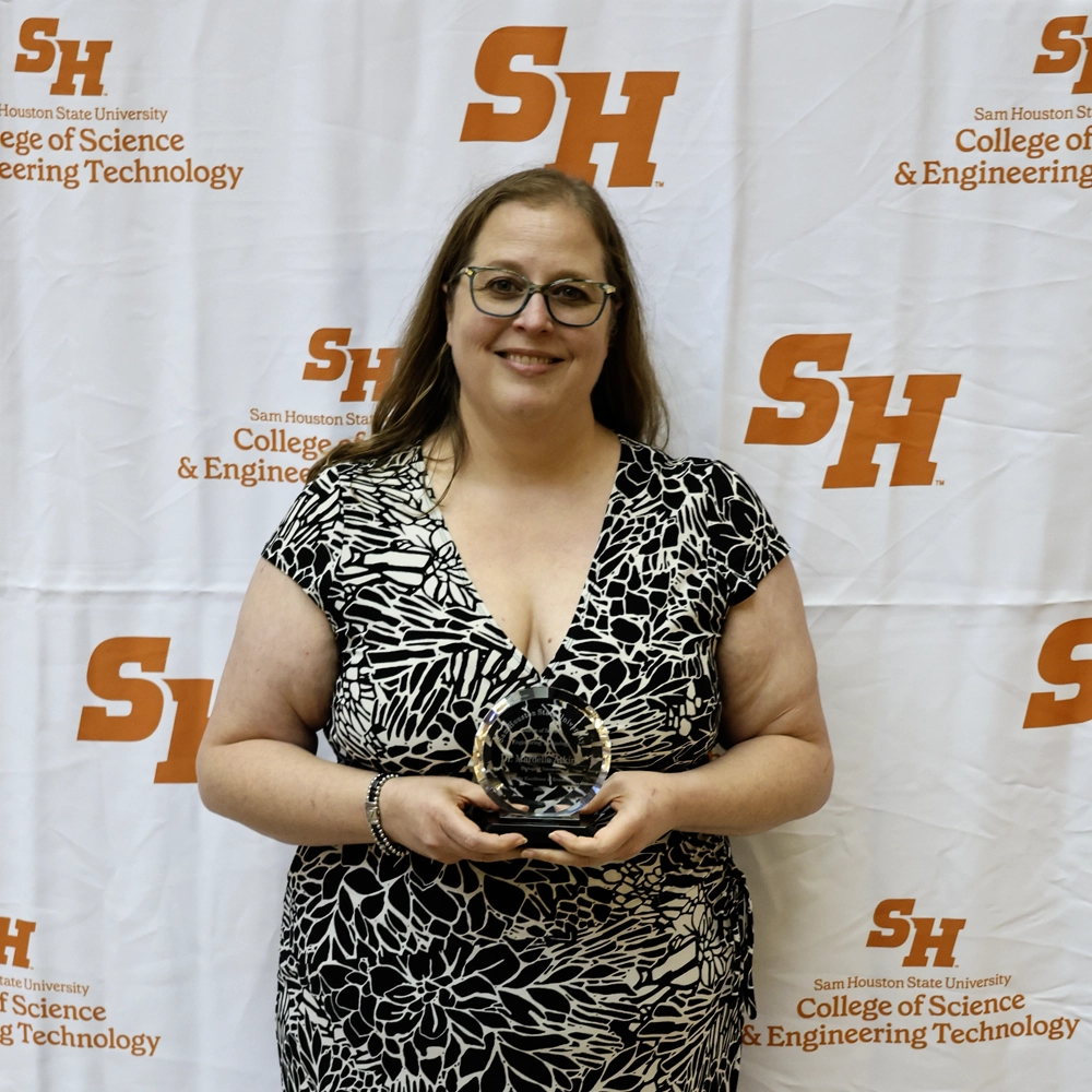 Dr. Atkins holding her award