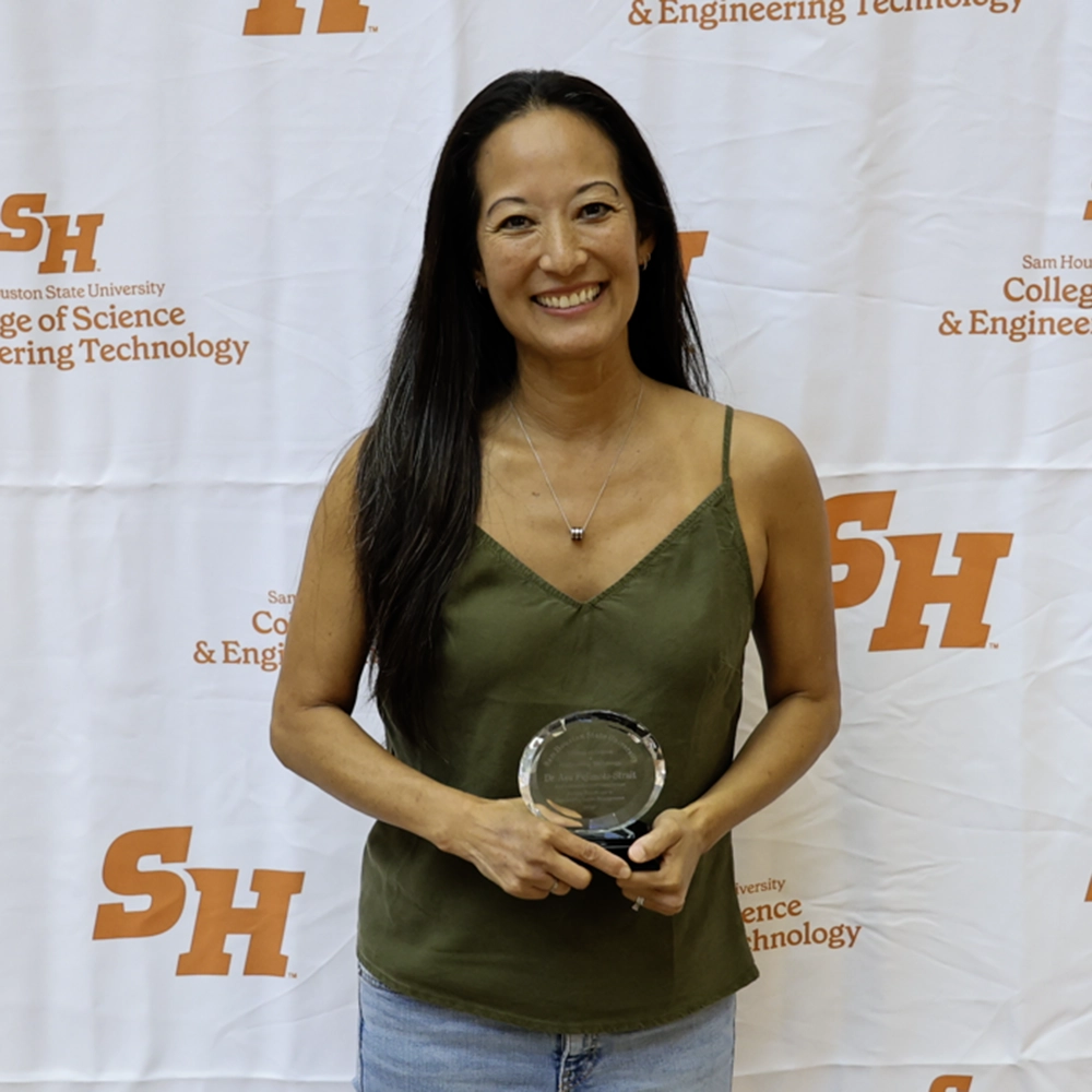 Ava holding her award