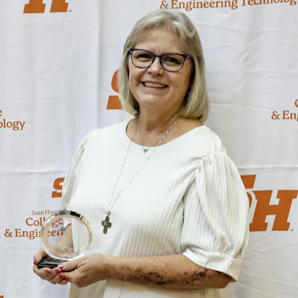 Nanette holding her award