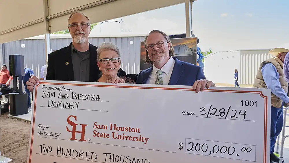 Joel Walker, Mike Prokosch and Mrs. Dominey at the grand opening