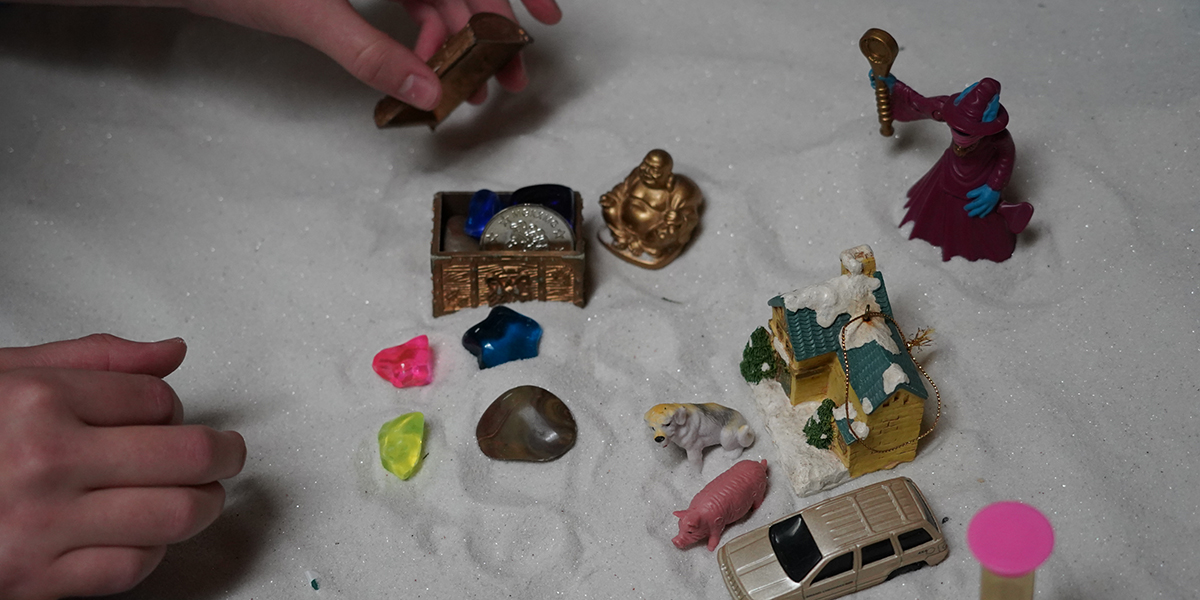 a sandtray with scattered toys inside