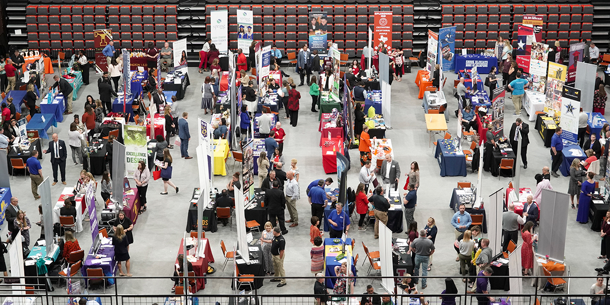 birds eye view of many different poster board presentations among a crowd of people