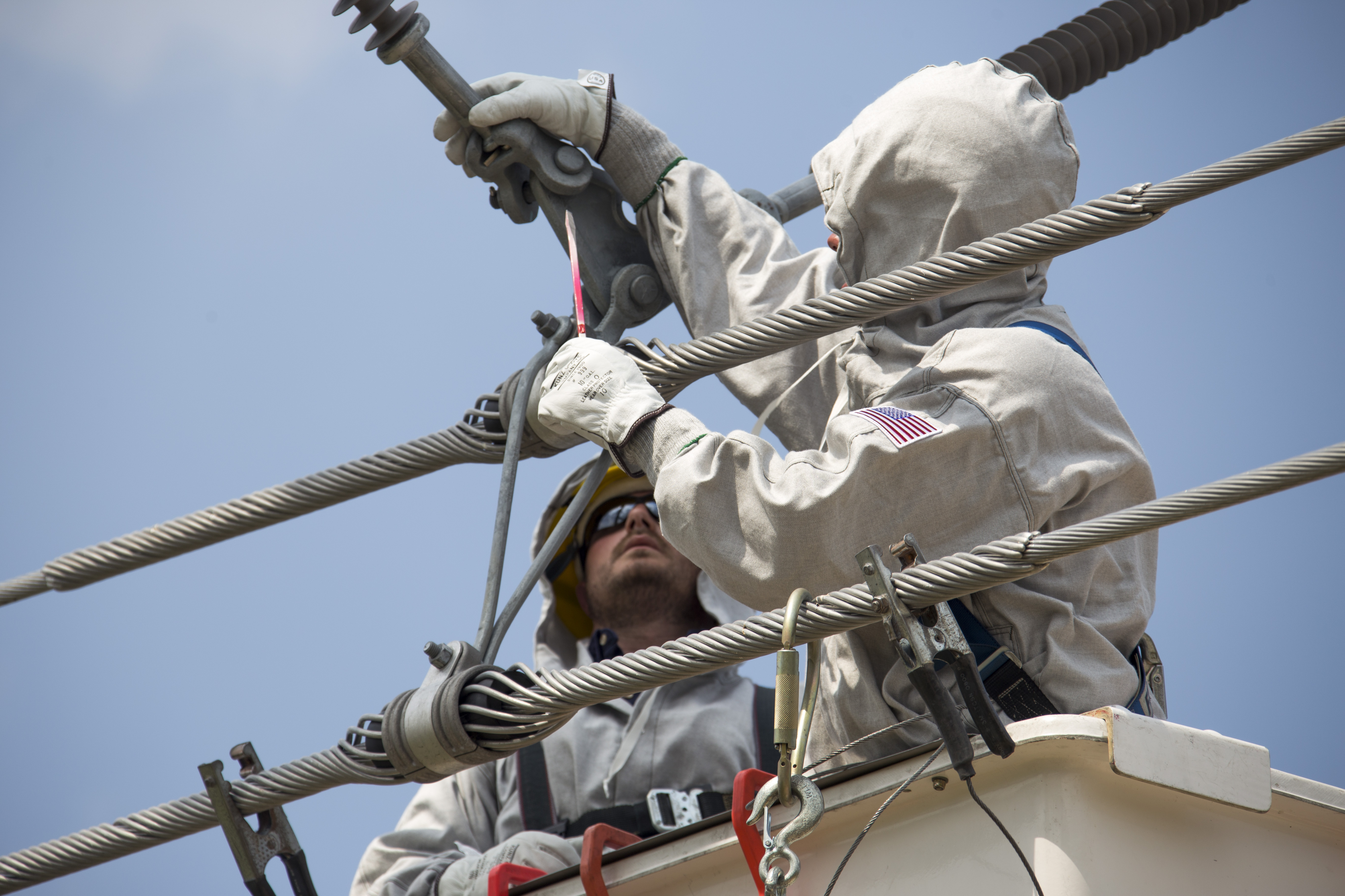 Two engineers working on power cables