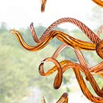 Detail of the bright orange spiraled blown glass artwork by glass artist Jason Lawson