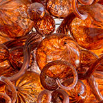 Bright orange mass of spiraled blown glass artwork by glass artist Jason Lawson