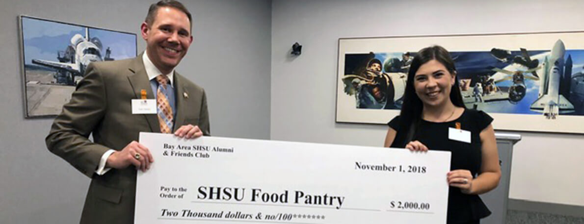 Bay Area Alumni Club presents check to SHSU Food Pantry