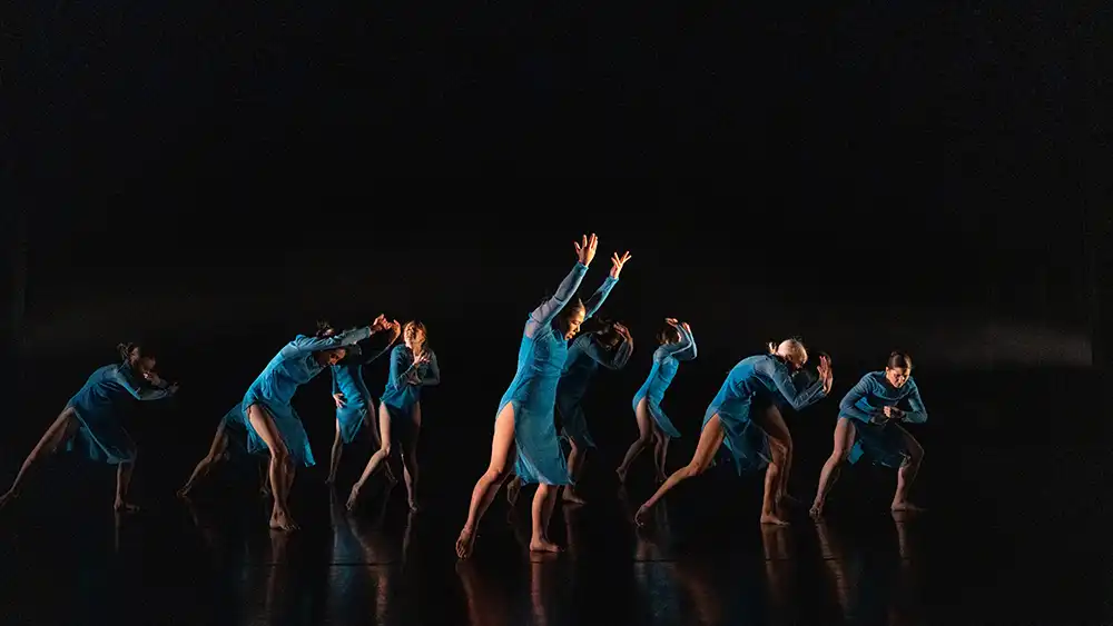 Dancers in motion on stage.