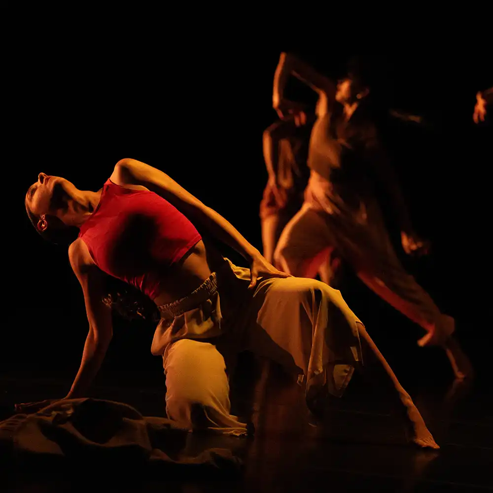 Dancers in a dark studio