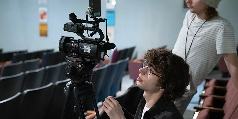 Student Holding Camera