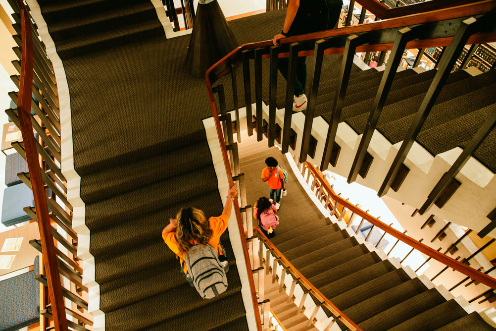 SHSU students navigate the stairs in the Newton Grisham Library.