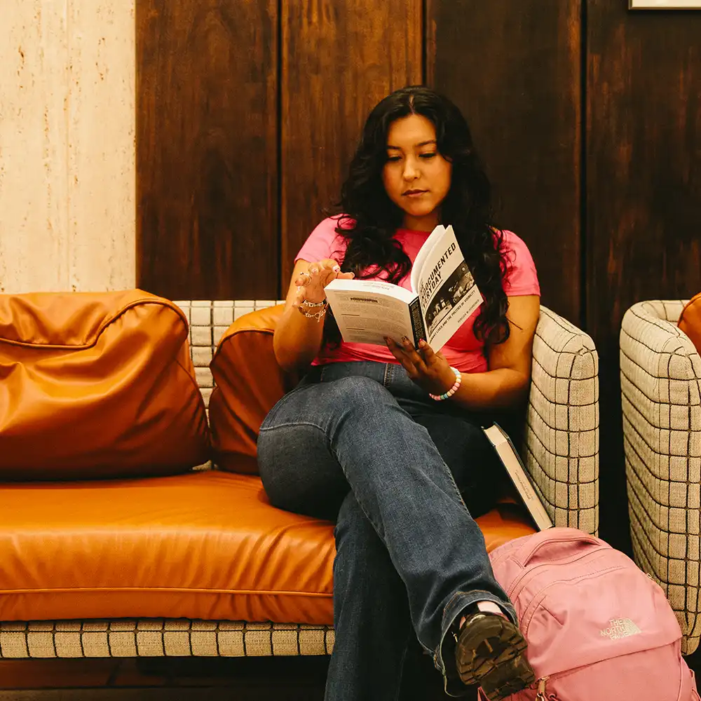 Student reading in the Newton Grisham Library