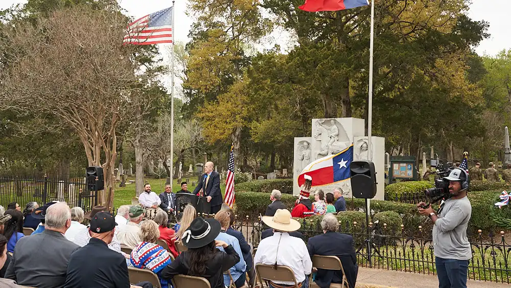 Man in suit talking to another man