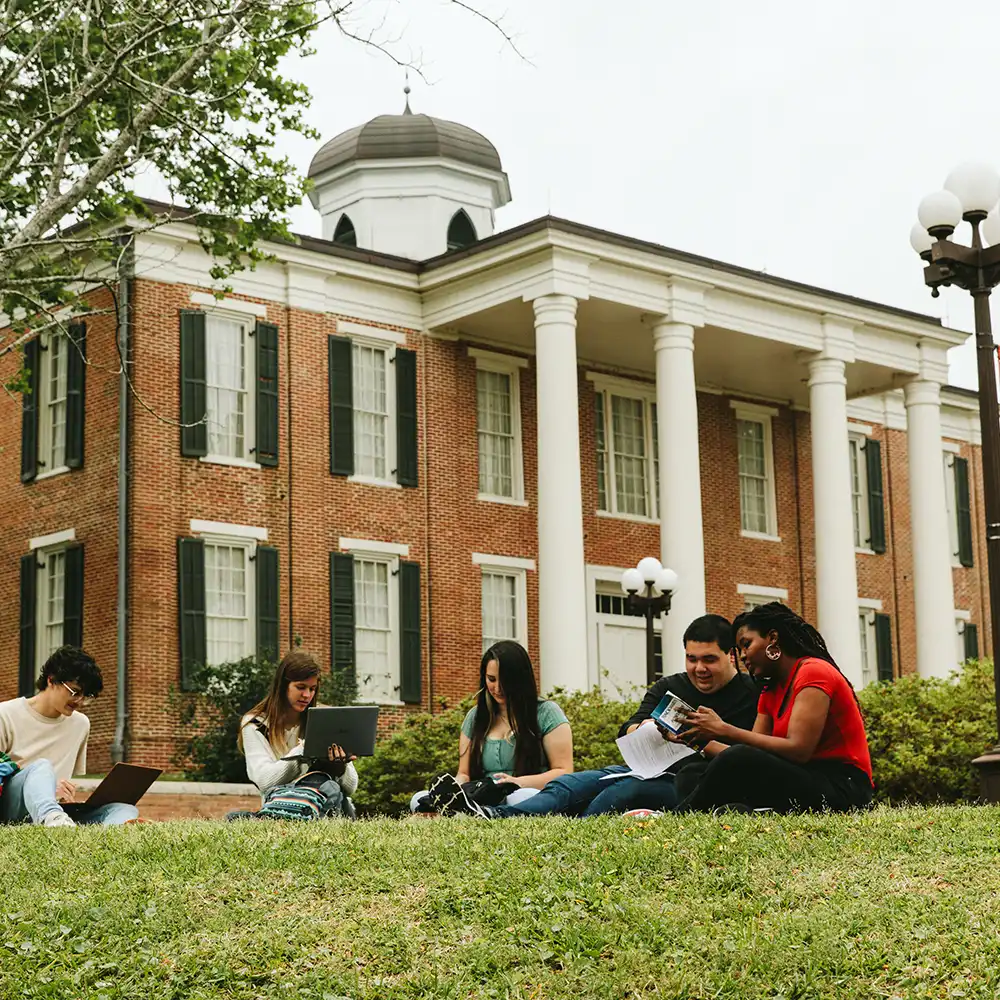 SHSU students study on the lawn in front of Austin Hall.