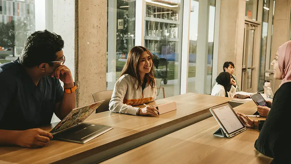 Students sitting at table deep in discussion.