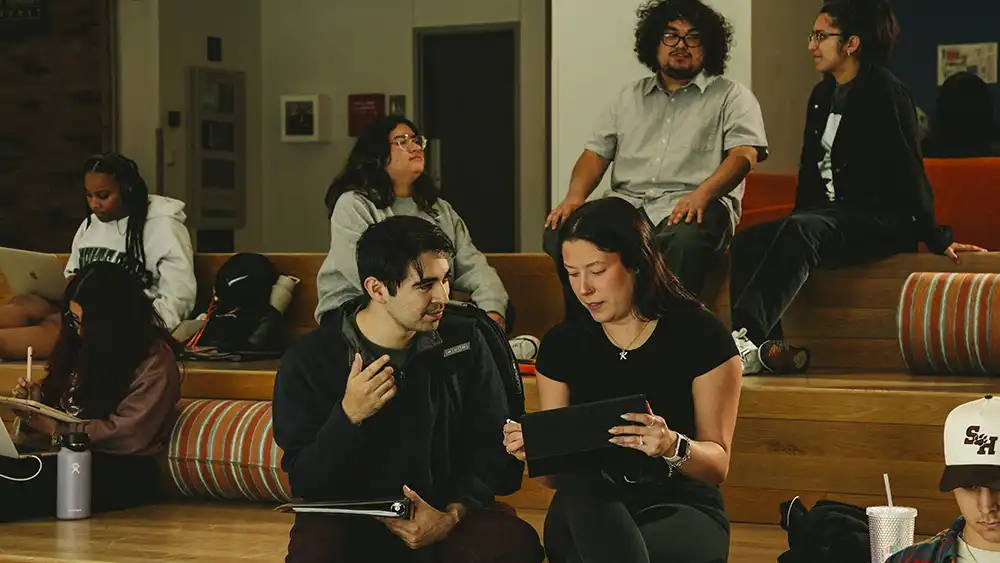 Man in suit talking to another man