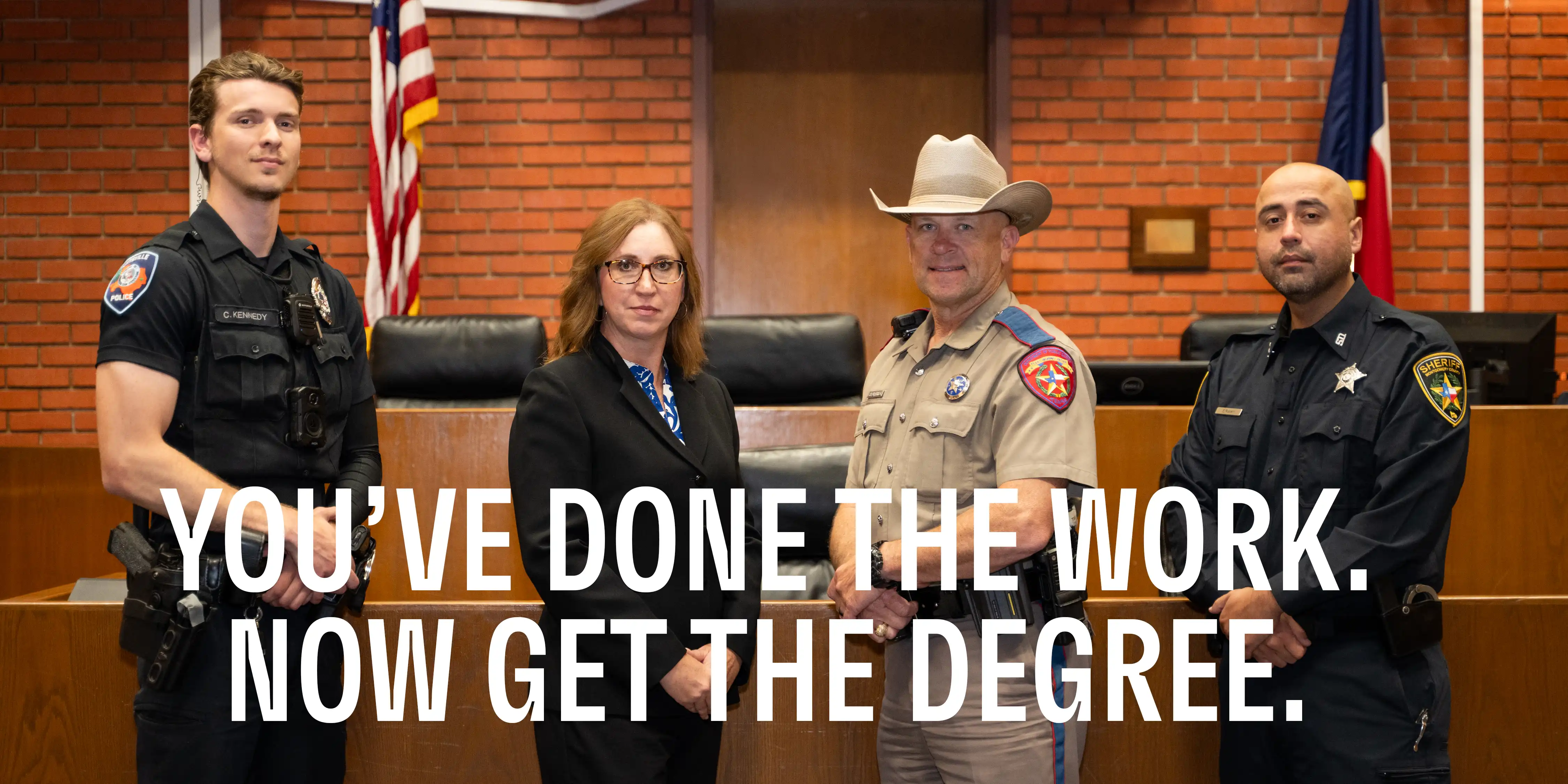 Group of law enforcement professionals standing in courtroom with text overlay that reads, "You've Done the Work. Now Get the Degree."