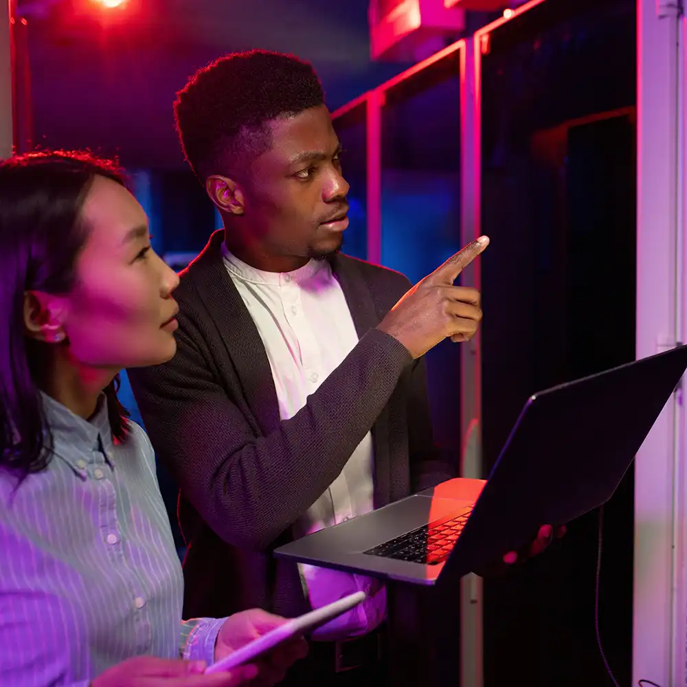 Graduate student working on laptop computer in classroom
