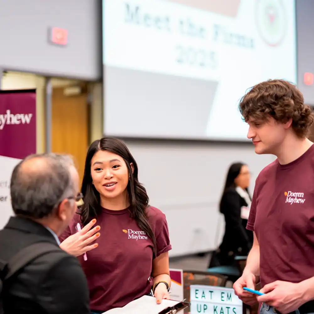Two business students meeting with a recruiter.
