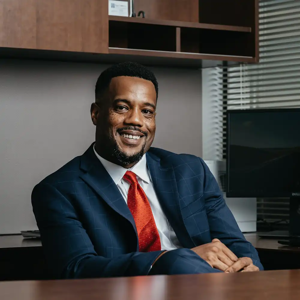 Business Professional smiling at desk.