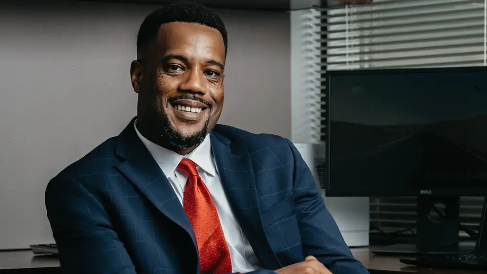 Business Professional smiling at desk.