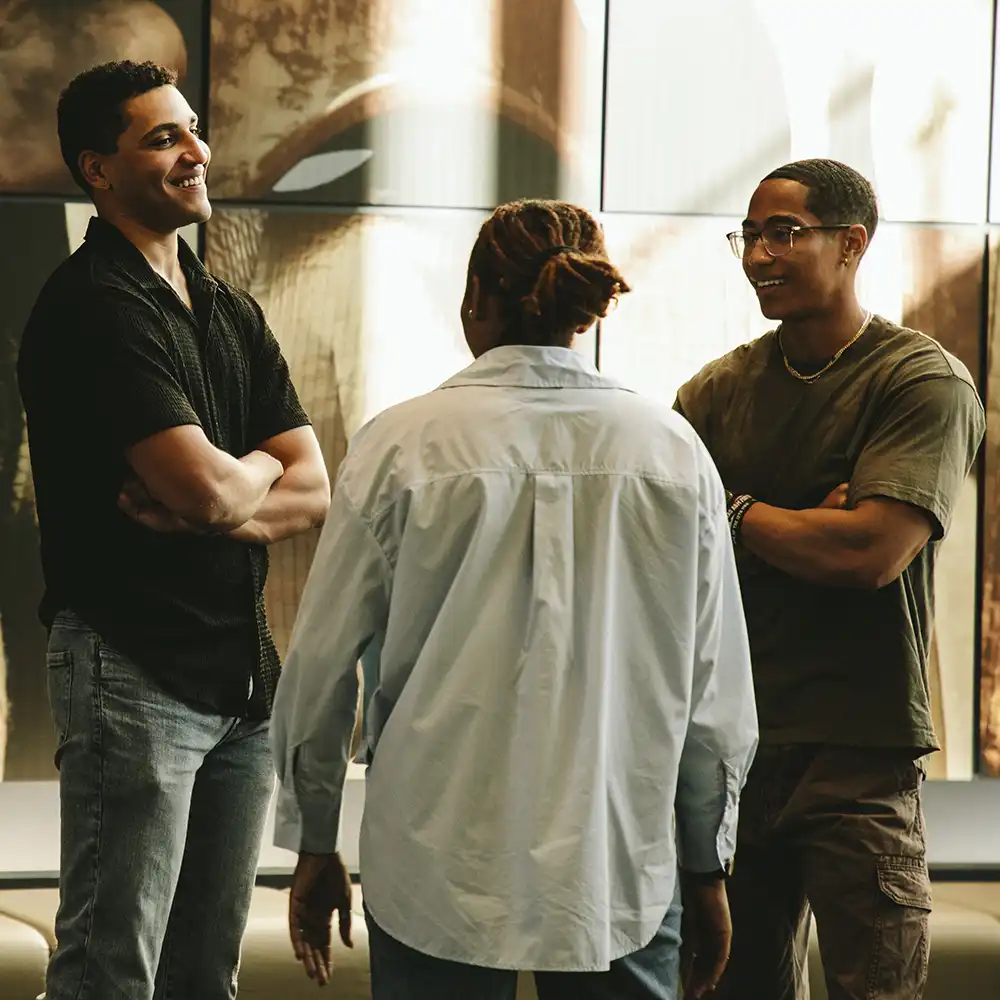 Students discussing something near an art piece.