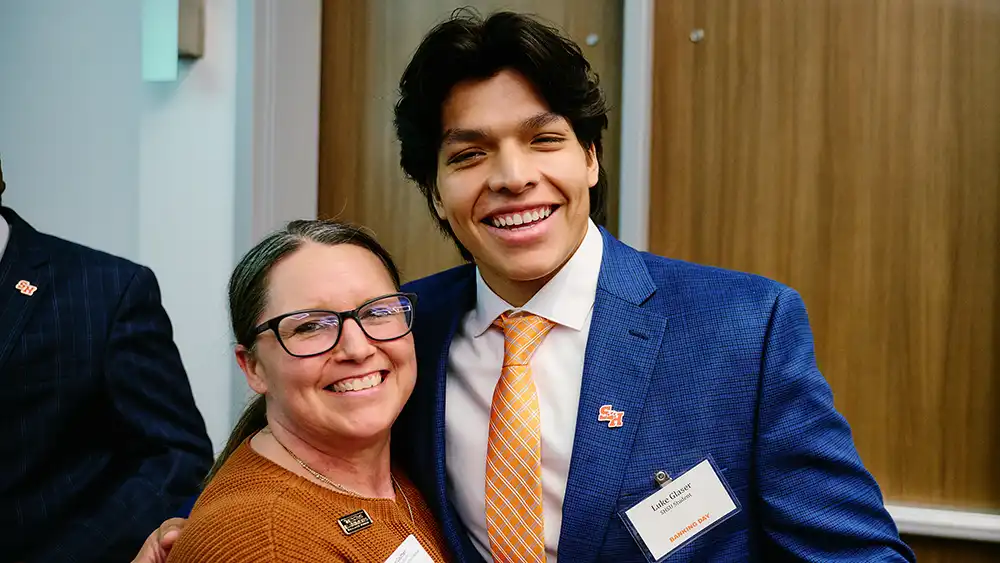 Man in suit talking to another man