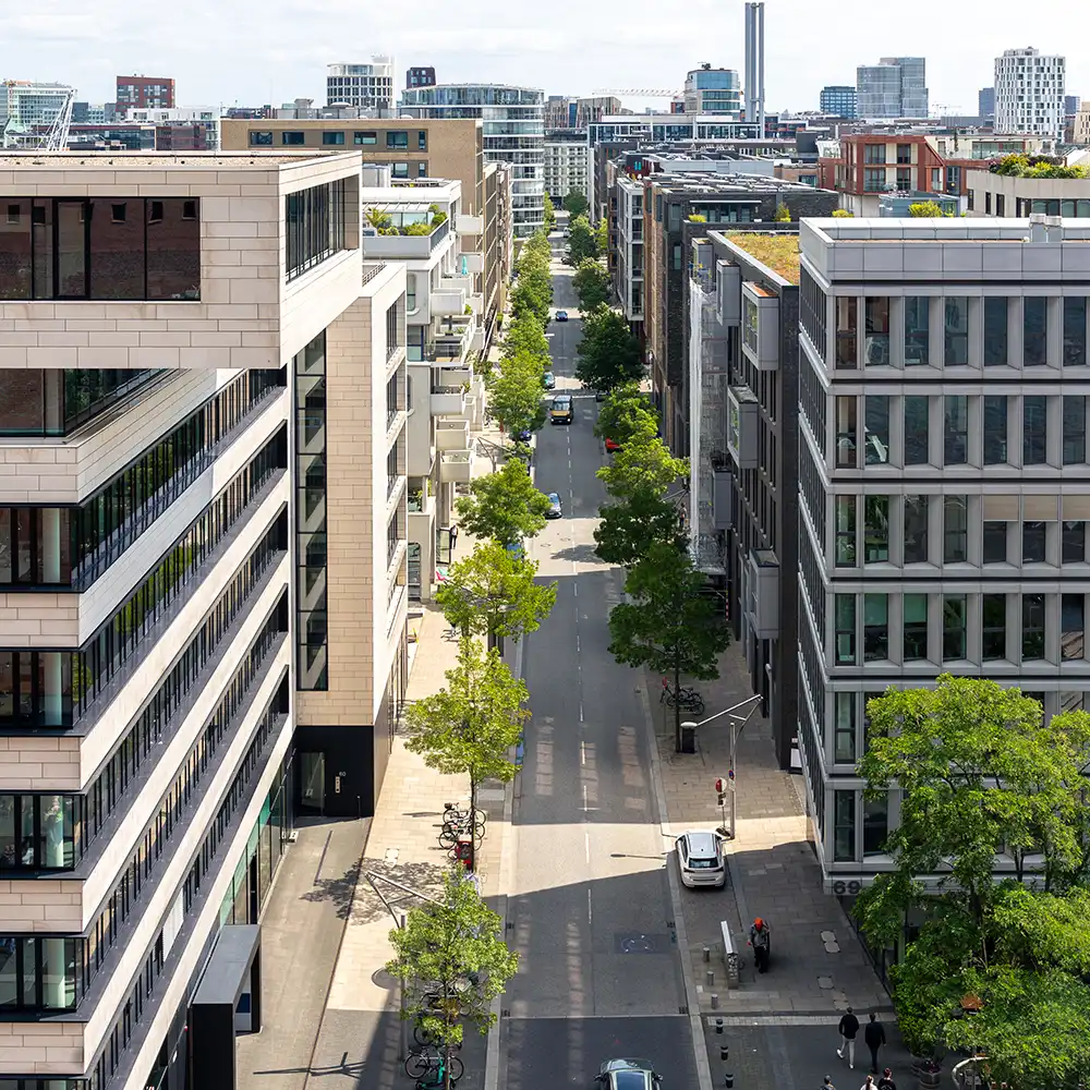 Aerial picture of a city street, with 4-5 story buildings on either side.