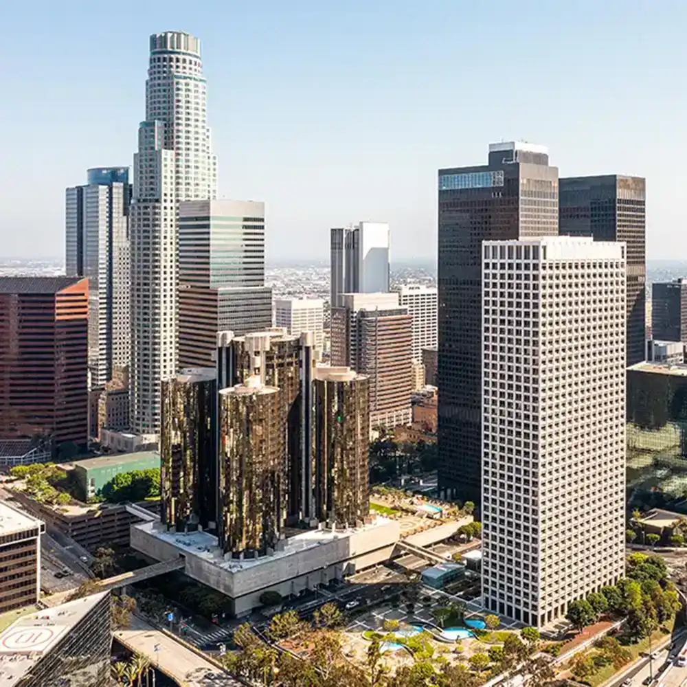 Aerial photo of a large city, with skyscrapers and some roads visible.