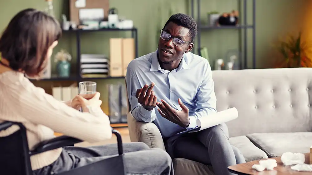 Man in suit talking to another man