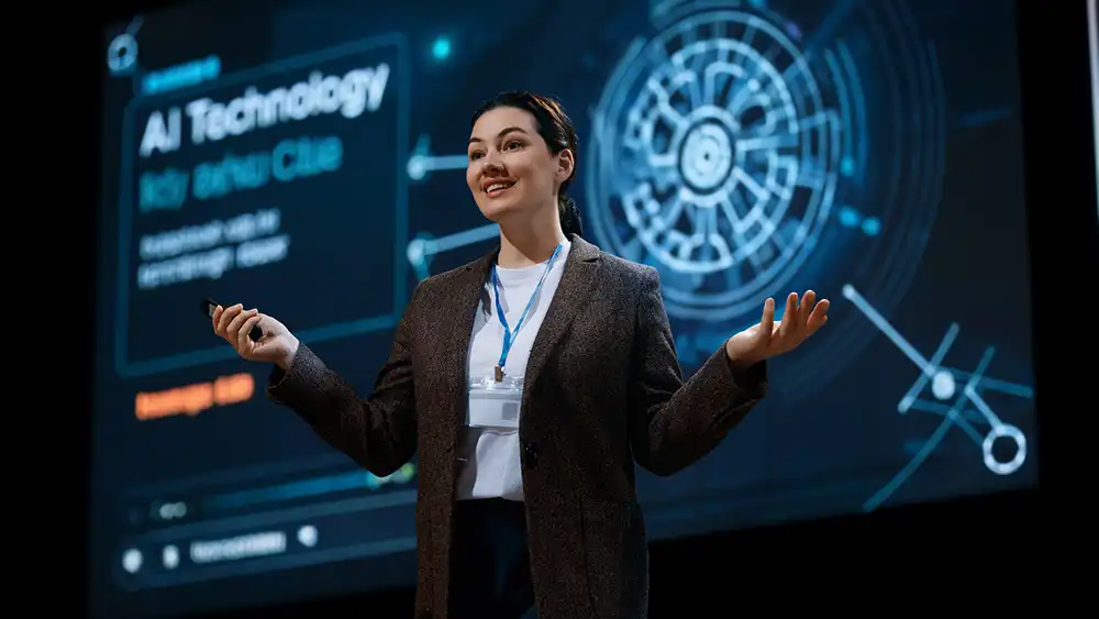 Professor speaking to the class with a slide on AI technology behind her.