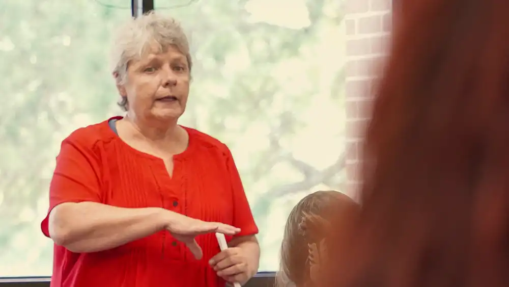 Female professor lecturing a college class