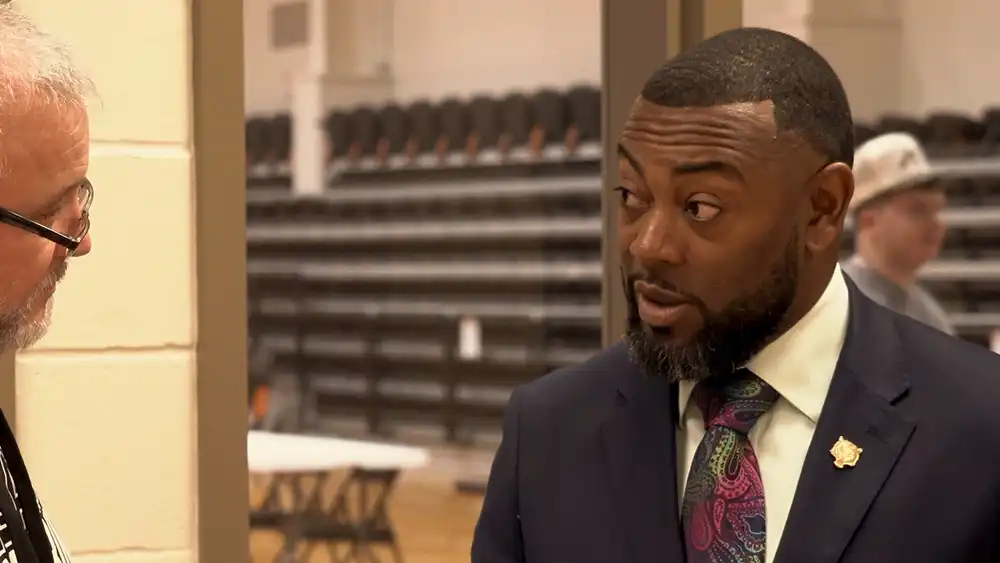 Man in a suit talking to another man