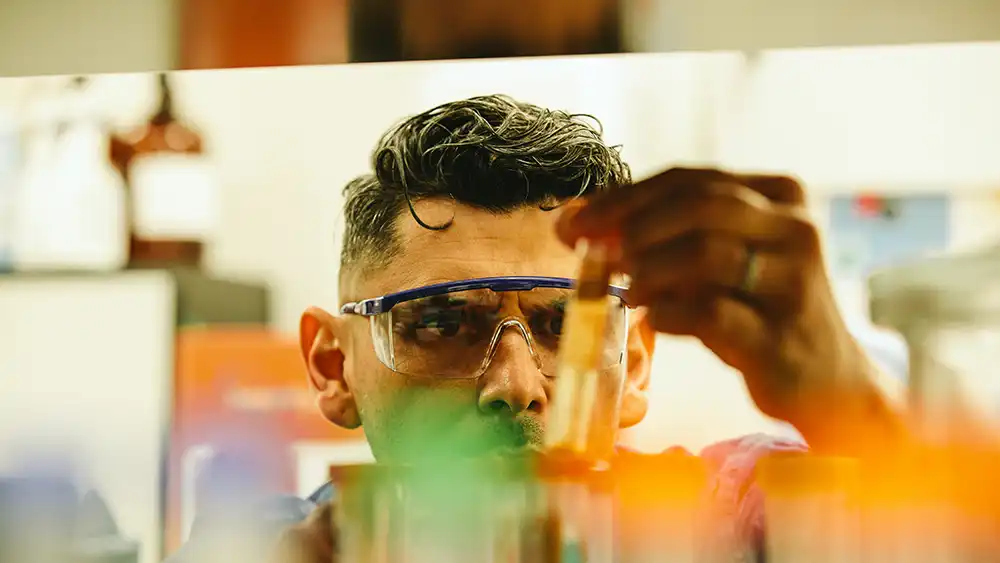 Student working in a Lab holding vials