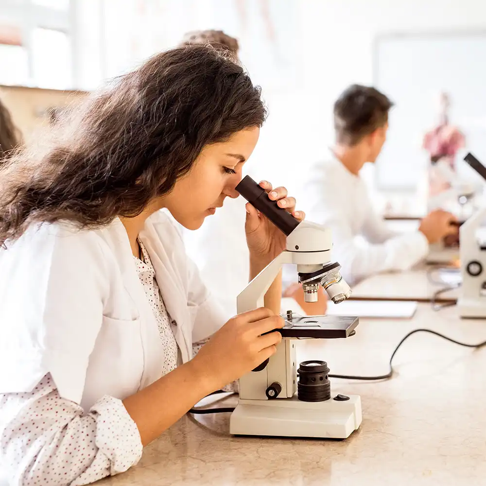 Woman student looking in microscope