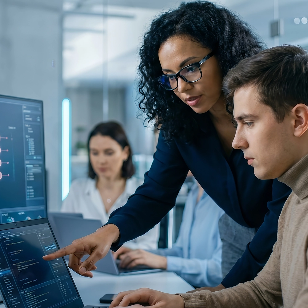 Supervisor talking to worker in an IT server room