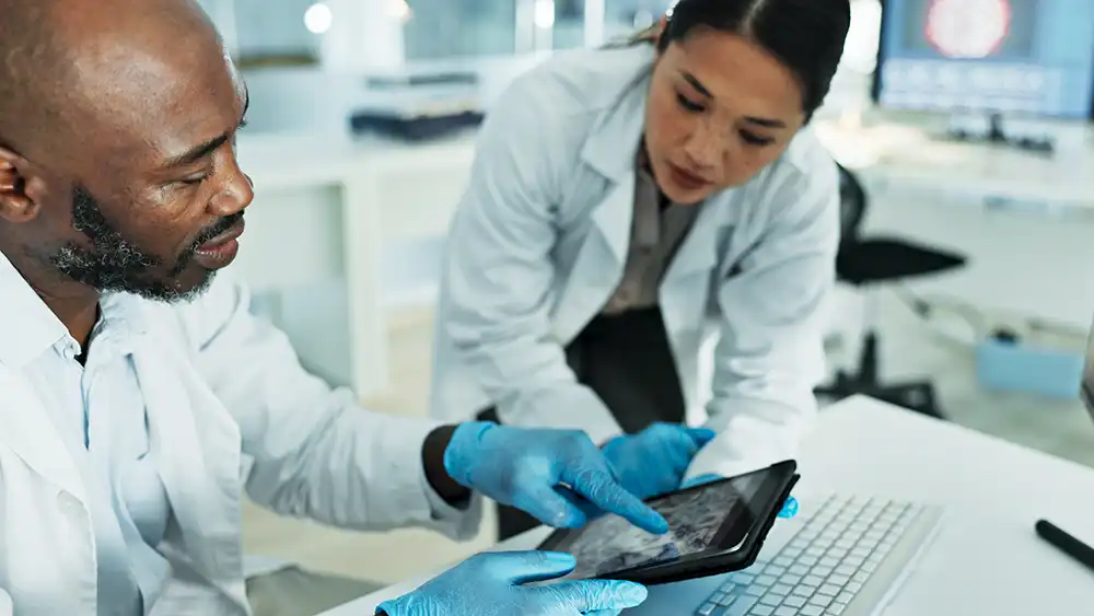 Scientists are examining an electronic tablet.