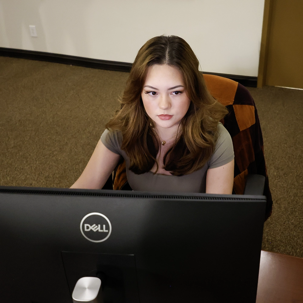 Woman looking at a computer screen in a lab. 