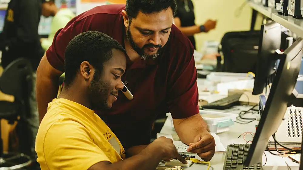 Electronic engineer student working with professor
