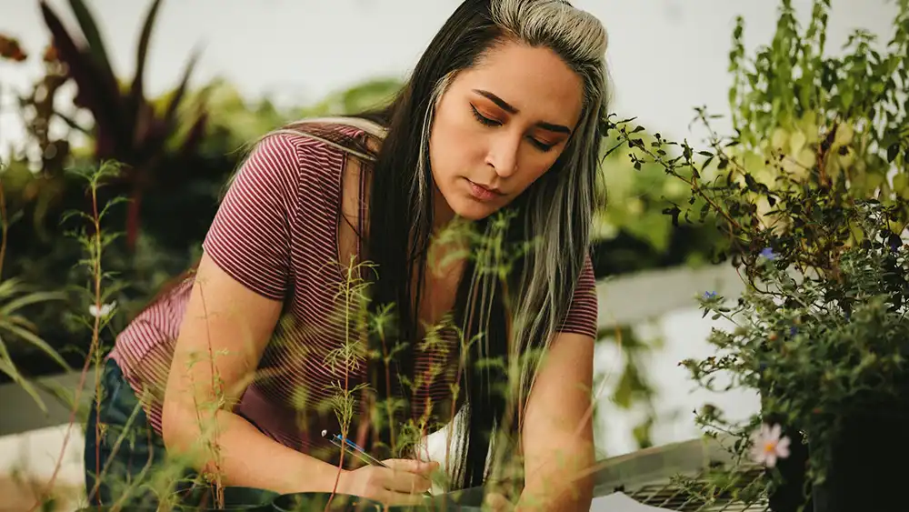 Student in greenhouse.