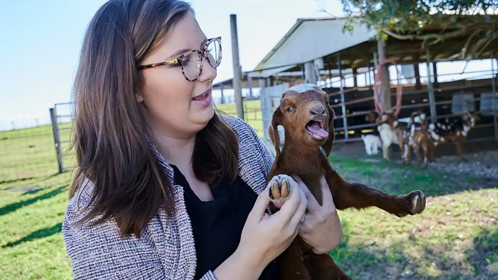 Student with lamb at Gibbs Ranch