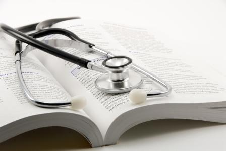 Stethoscope resting on a book