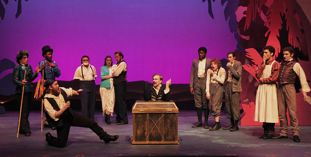 SHSU theatre actors on stage behind a box in  Peter and the Starcatcher