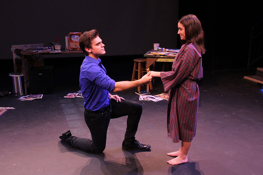 SHSU theatre actor kneeling in front of actress and holding her hand on stage in Credeaux Canvas 