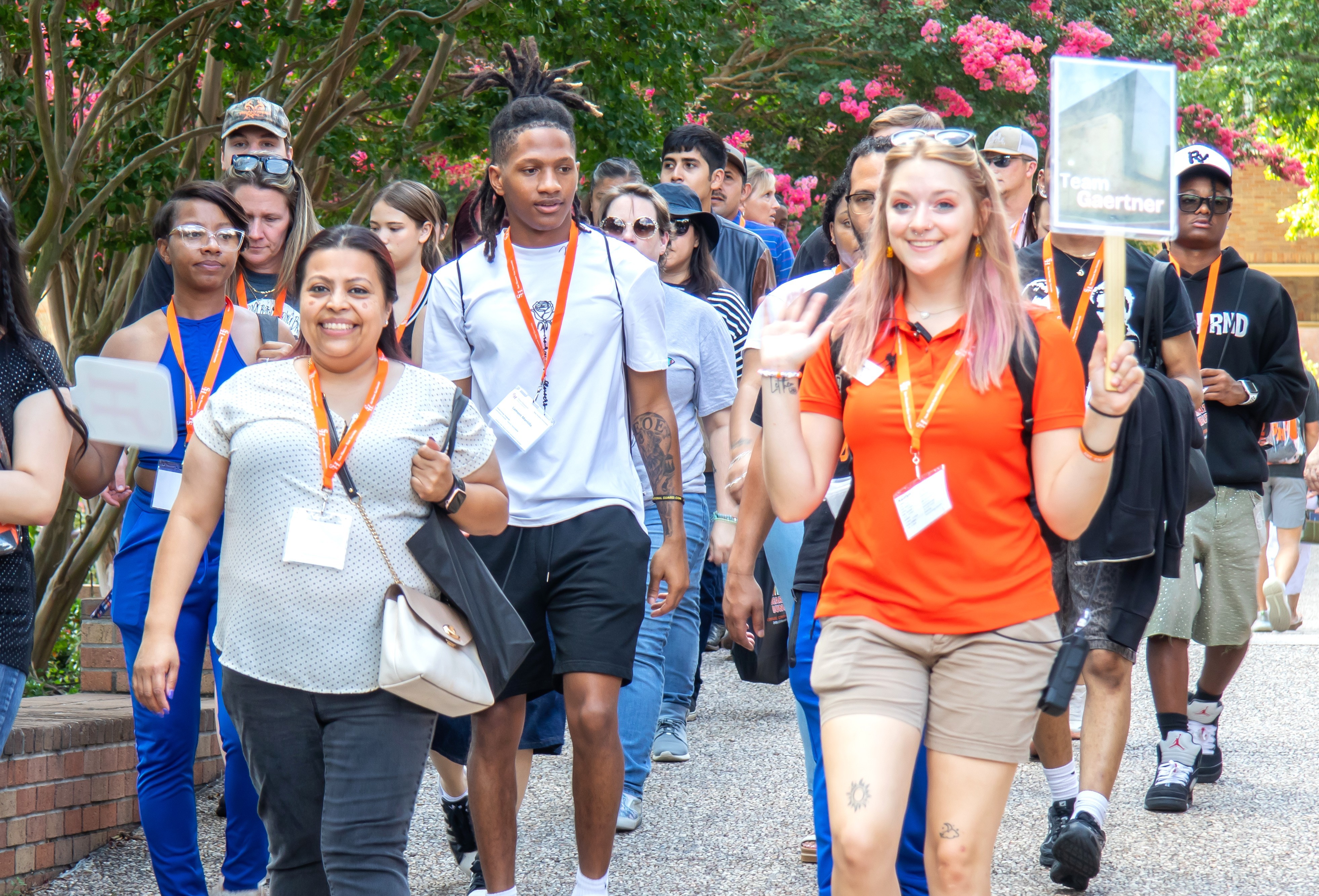 Parents smile as their student talks to people tabling at New Student Orientation.