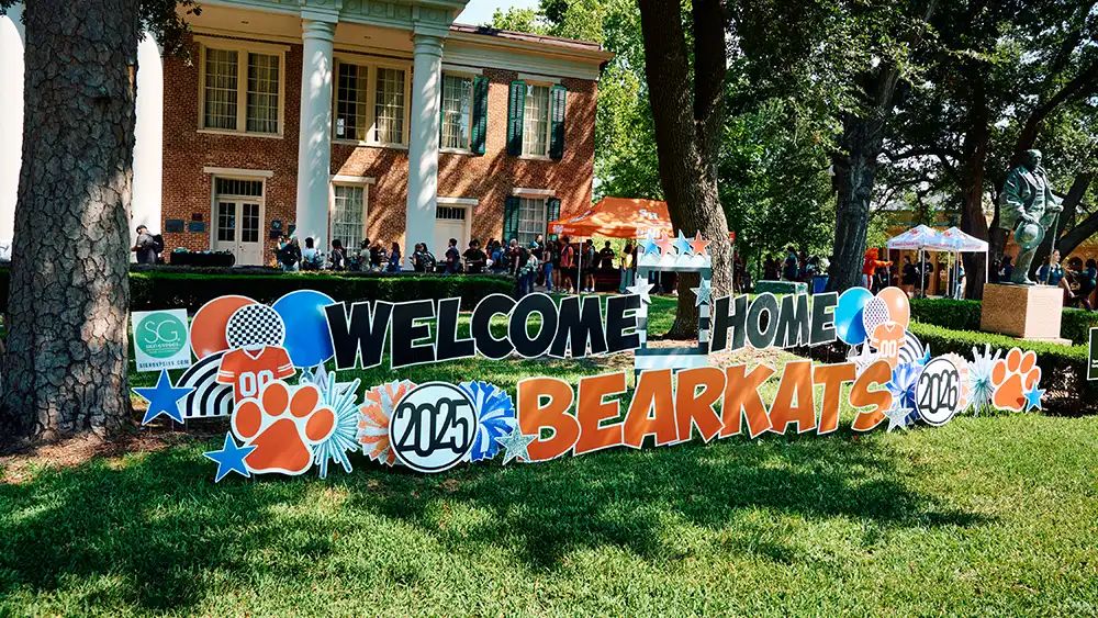 Sammy Bearkat standing and posing with a student at Bearkat Kickoff.