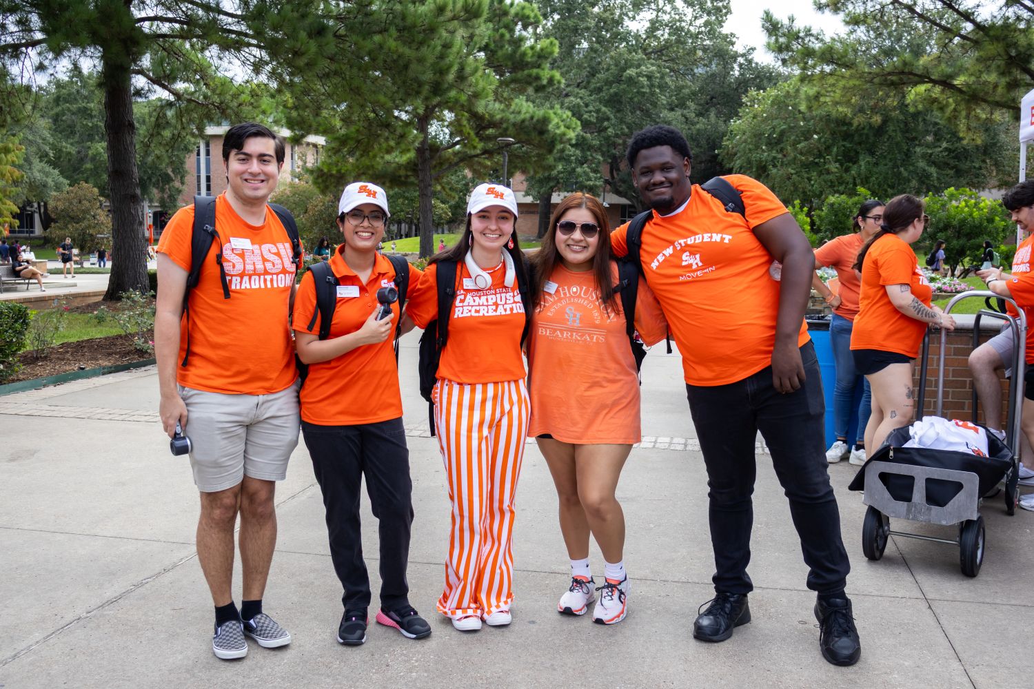 Students dressed in orange smiling