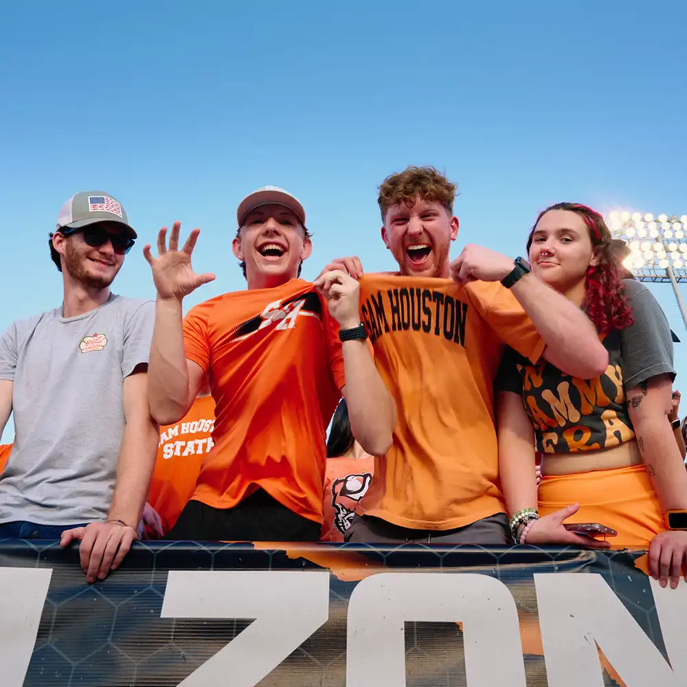 Bearkat Student Fans showing off their SHSU shirts at the Homecoming Football Game in the student section.