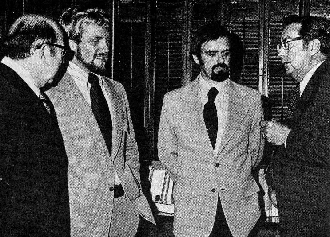 From left, George Killinger, Randall McCauley, Ronald Waldron an Elliot Bowers chat after McCauley and Waldron's dissertations were approved.