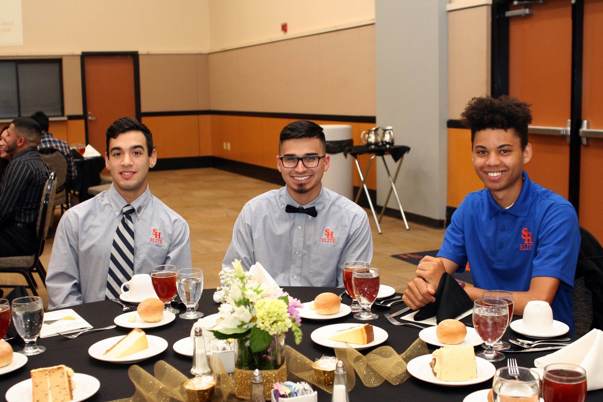 Three SH Elite Students sit at a table.